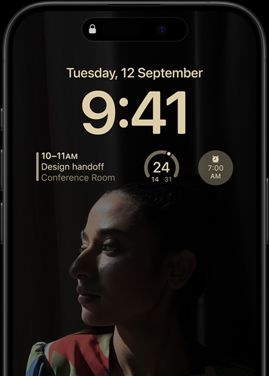 The Always-On display of iPhone 15 Pro showcasing a Lock Screen with a calendar widget, a weather widget, and an alarm widget